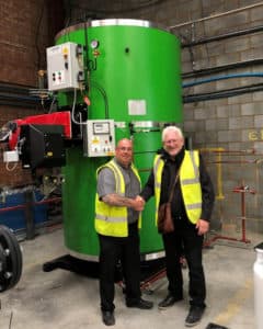 Dave Firth and David Parrish in front of a Vertical Steam Boiler.