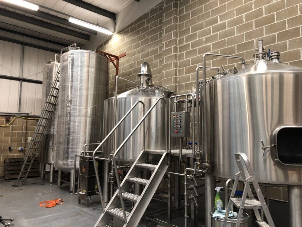 During install of a Suffolk Micro brewery. Mash Tun, Coppers & Fermentation Vessels R-L.
